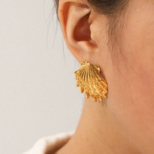 18k gold plated stainless steel seashell earrings worn by a model for a beach style look