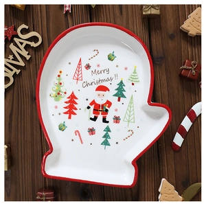 Detail of glove-shaped ceramic Christmas plate with Santa and Merry Christmas text