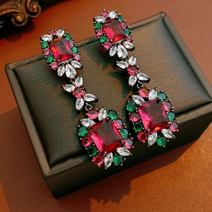 Close-up of vintage square drop earrings with colorful zircon stones on jewelry box