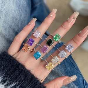 Macro shot of 11 multi-colored square-cut zircon rings with micro-pave silver bands