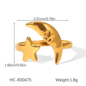 Detail view of 18K gold star and moon open ring with dimensional face relief carving