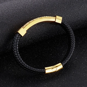 Detail of men's braided leather bracelet with gold magnetic clasp and curved metal plate