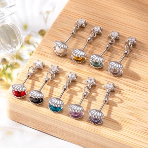 Star shell cartilage studs in various colors arranged on a rustic wooden background