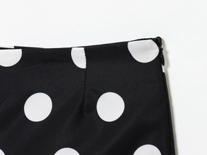 Detail shot of the invisible zipper and waist stitching on black polka dot high waist shorts