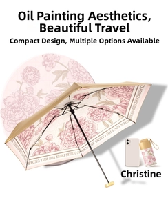 Detail of floral oil painting lining on compact champagne gold sun umbrella with case