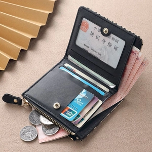 Mini black textured zip wallet with card slots and ID window flat on beige surface