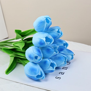 Close-up of blue PU moisturizing artificial tulips on a book for home decor