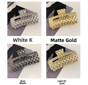 Macro detail of metal hair claw clips with diamond texture in four stylish colors