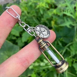 Close-up of bronze kerosene lamp pendant and silver circular plate with Granddaughter engraving