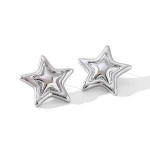 Macro shot of silver polished double-layered star-shaped stainless steel stud earrings