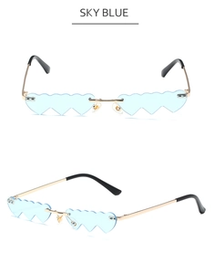 Close-up of sky blue heart-shaped sunglasses with golden metal frames and clear lenses
