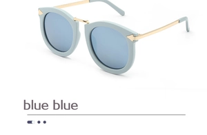 Detail view of light blue round cat-eye sunglasses with golden metal temples and nose bridge