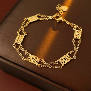 Detailed close-up of a vintage hollow flower bracelet on a dark textured jewelry box