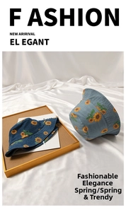 Detail of blue denim bucket hat featuring vibrant yellow sunflower print on silk fabric