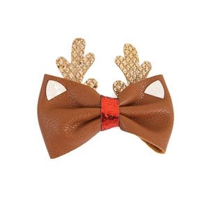 Christmas reindeer antler hair clips with gold glitter and red sequin bow on white background