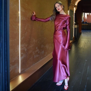 Elegant wine red satin evening gown featuring long sleeves and floor-length slit detail