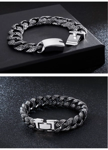 Close-up of vintage engraved stainless steel chain link bracelet with clasp details