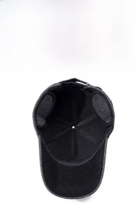 Close-up of winter baseball cap featuring fold-down ear flaps and warm herringbone wool