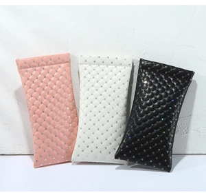 Detail view of quilted PU leather sunglass pouches in pink, white and black colors