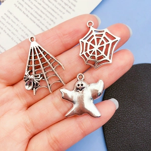 Antique silver Halloween charms featuring spider web and ghost shapes in alloy