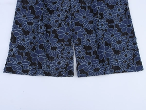 Detail of blue floral embroidery on black mesh fabric with elegant lace texture