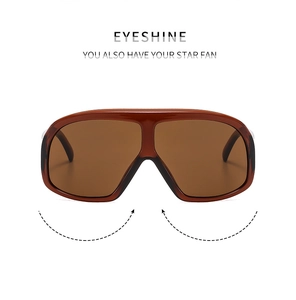 Detail of oversized retro sunglasses with brown transparent frames and flat top design