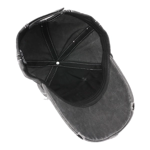 Detail view of cotton inner lining and stitching on distressed charcoal baseball cap