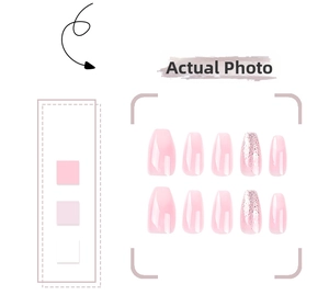 Close-up of pink gradient press-on nails with glitter details in a coffin shape