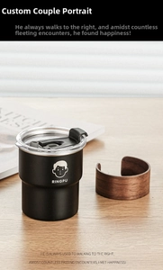 Detail shot of a matte black stainless steel camping mug with a clear lid and cartoon logo