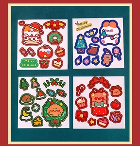 Detailed view of four colorful Christmas themed cartoon stickers featuring Santa and trees