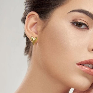 Polished gold heart stud earrings shown on model for women minimalist stainless steel jewelry