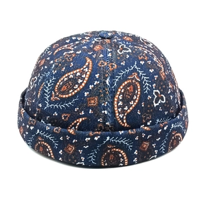 Detailed view of dark blue paisley canvas docker hat with vintage street style print