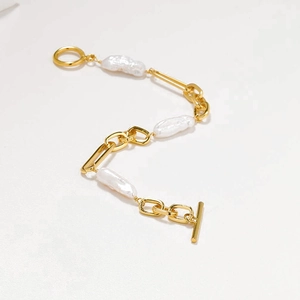 Baroque pearl gold chain bracelet with OT toggle clasp on a clean white background
