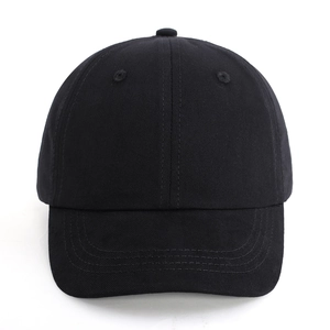 Close-up of black cotton baseball cap showing classic 6-panel structure and curved brim stitching