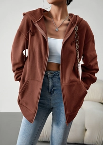 Detail view of a brown fleece zip-up hoodie with adjustable drawstrings and front pockets