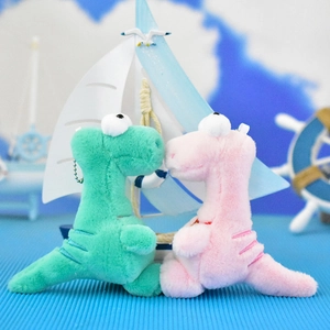 Pair of cute dinosaur plush keychains in green and pink colors for backpack charms