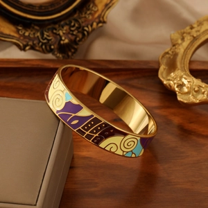 Artistic enamel bangle with purple and blue abstract patterns on gold metal base