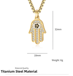 Detailed view of gold Hamsa Hand pendant with cubic zirconia stones and 32x18mm size specs