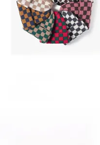Detailed view of colorful checkered knit beanies in various plaid color combinations