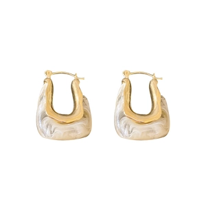 Fashionable gold U-shaped earrings with white marble resin texture on white background