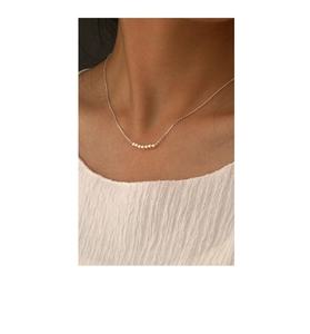 Minimalist S925 silver necklace with seven pearls worn on neck for a dainty look