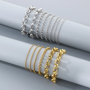 Minimalist titanium steel chain bracelets in gold and silver finishes on display stands
