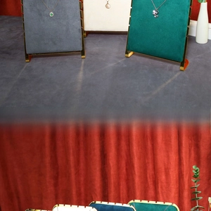 Detail of solid wood jewelry stand with metal frame and velvet for necklace display