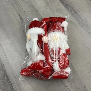 Detail of Christmas gnome refrigerator handle covers in red and white festive knit
