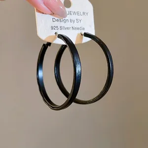 Close-up of black leopard print hoop earring with S925 silver needle on a card