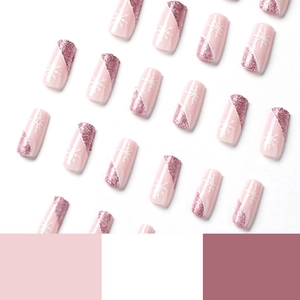 Pink press-on nails with white snowflakes and diagonal pink glitter in coffin shape