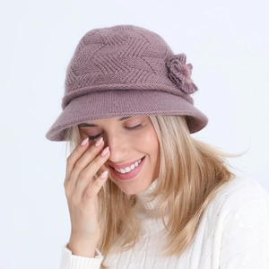 Detail of mauve knitted bucket hat with 3D flower decoration and thick wool texture