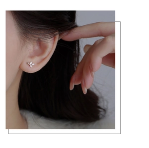 Macro shot of S999 sterling silver leaf stud earrings with sparkling zircon crystals