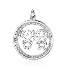 Detailed close-up of silver circular pendant featuring a hollowed boy and girl design