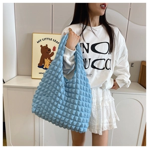 Detail shot of light blue popcorn bubble textured tote bag with unique 3D tactile fabric